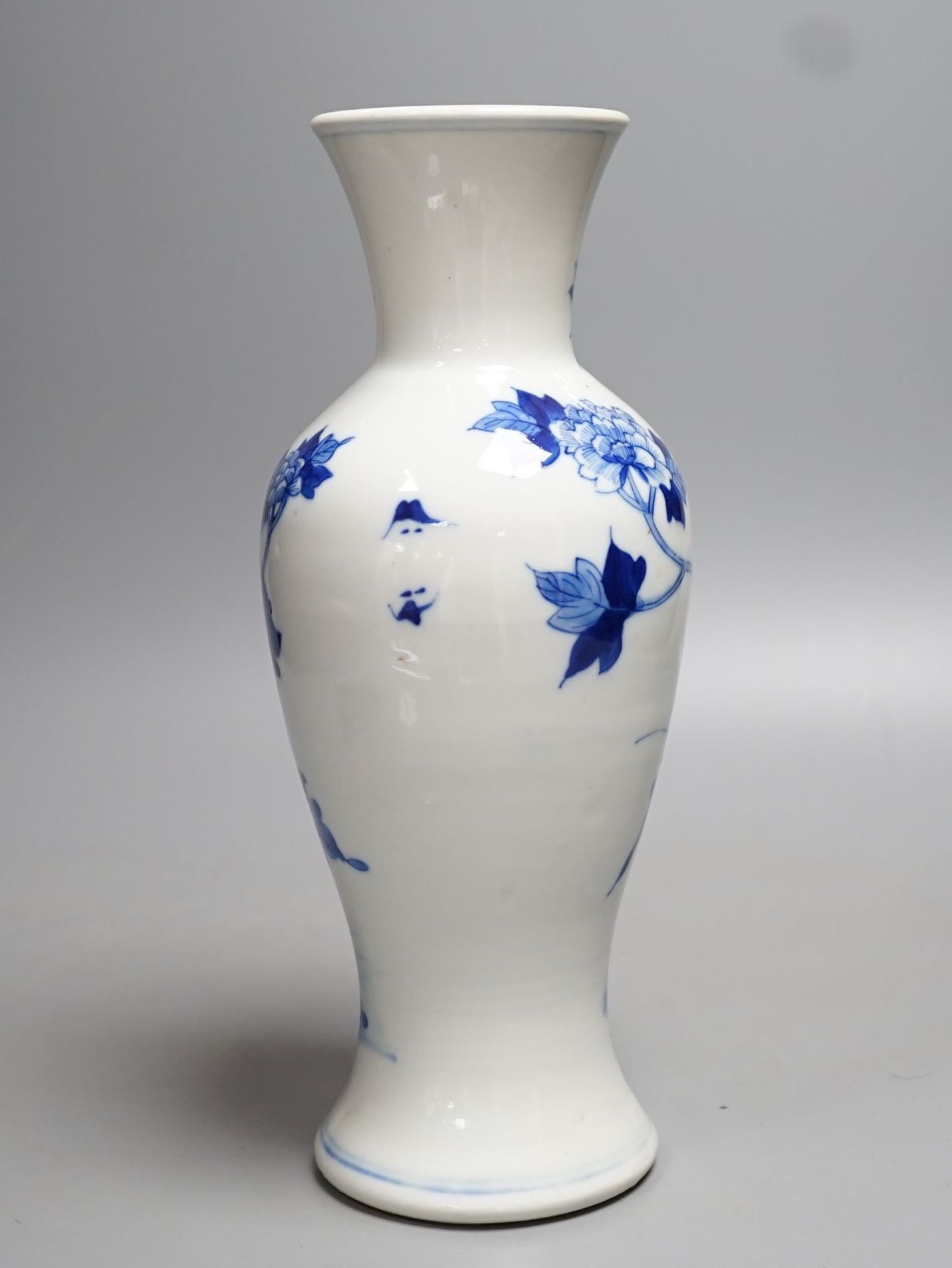 A late 19th century Chinese blue and white baluster vase, painted with birds amid flowers and rock work, pseudo Kangxi mark. 26cm